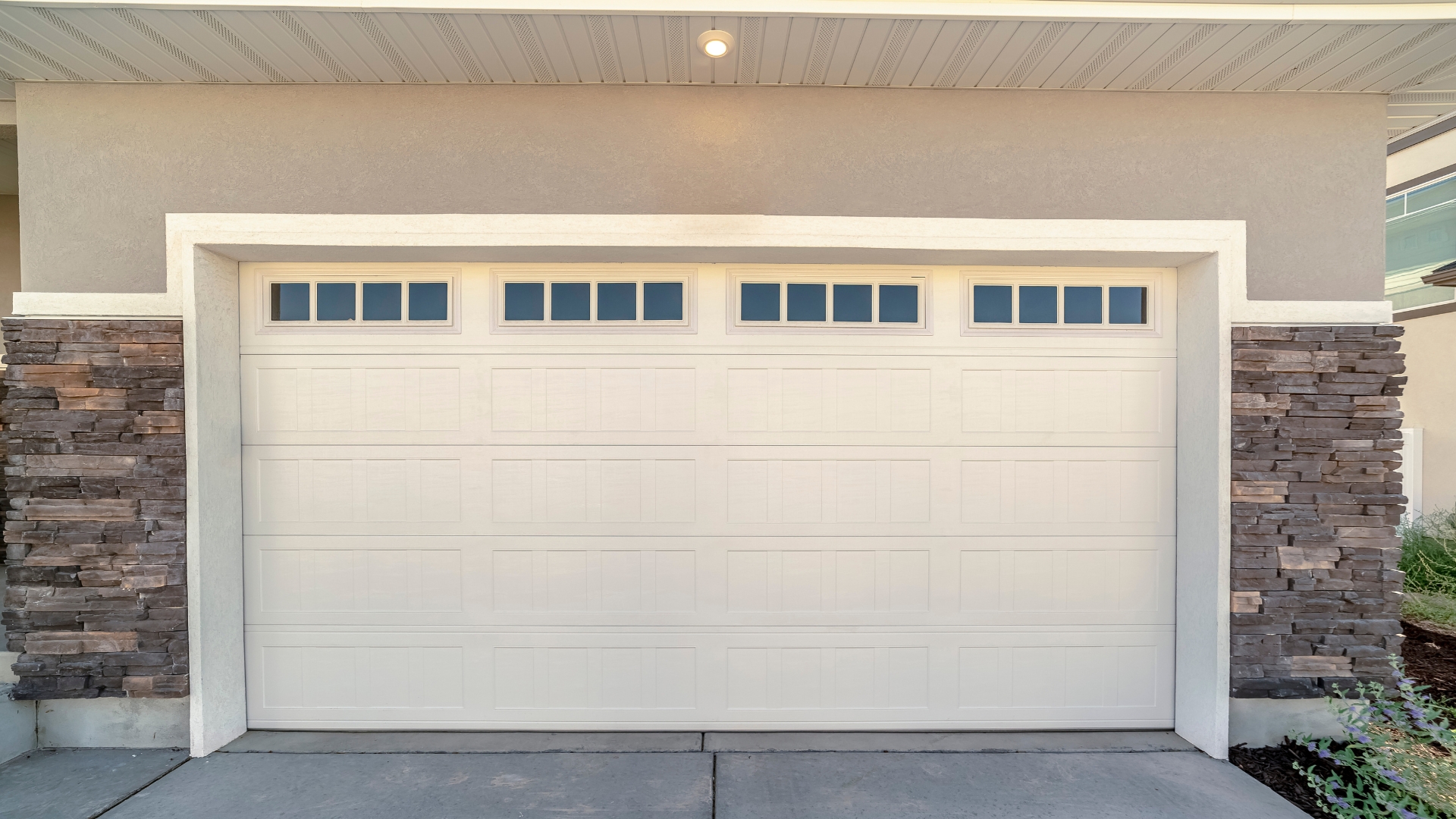 A garage door with window inserts. Garage door window maintenance is essential in keeping their aesthetics