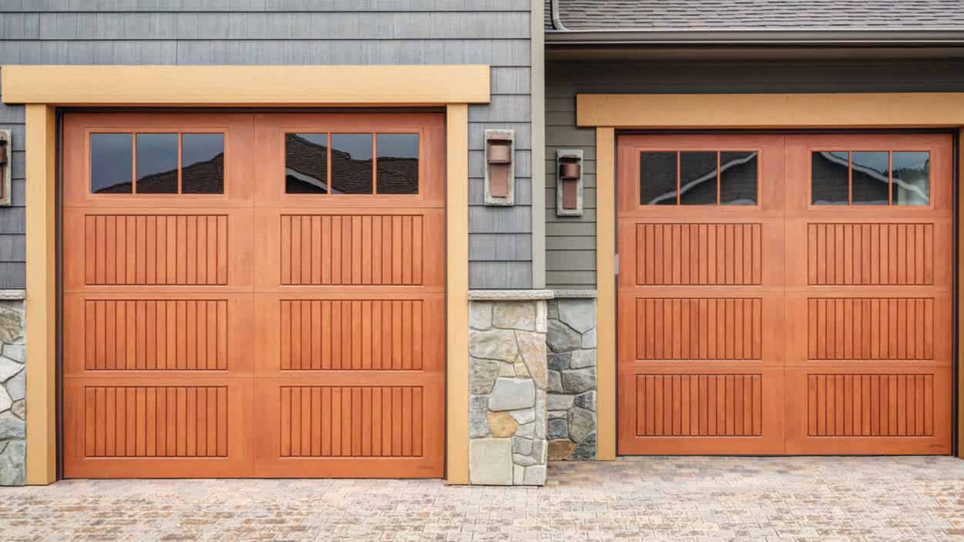 A home with two fiberglass garage door made to look like a wood