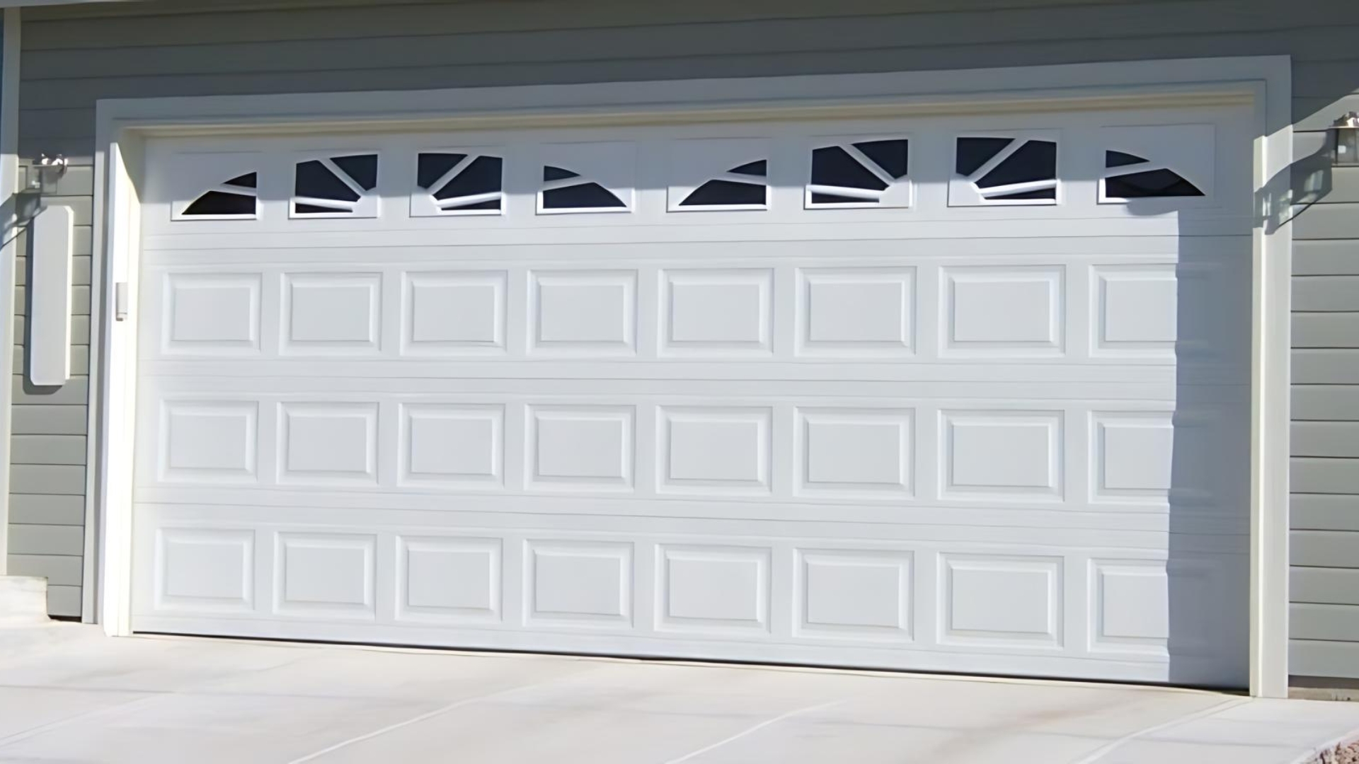 A steel garage door painted in white
