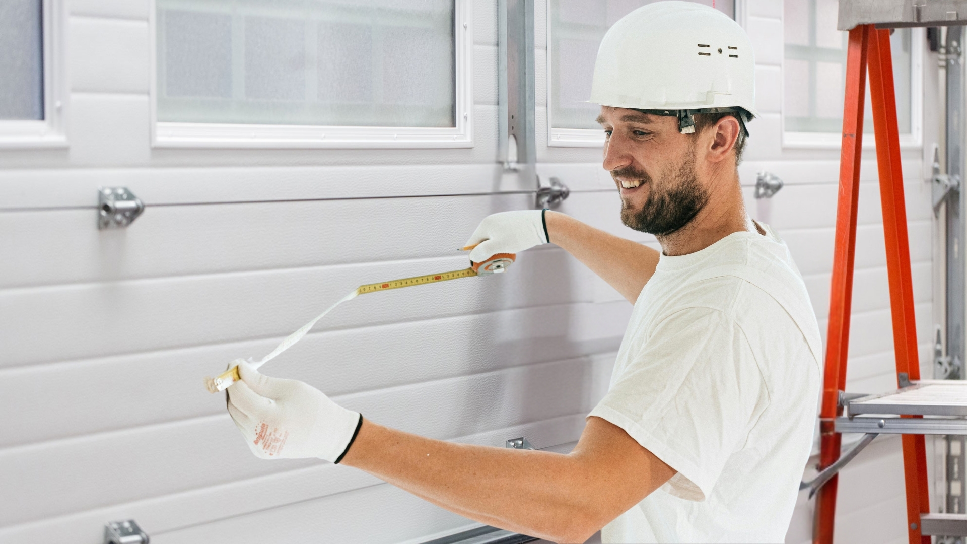 A garage door expert measuring the panels