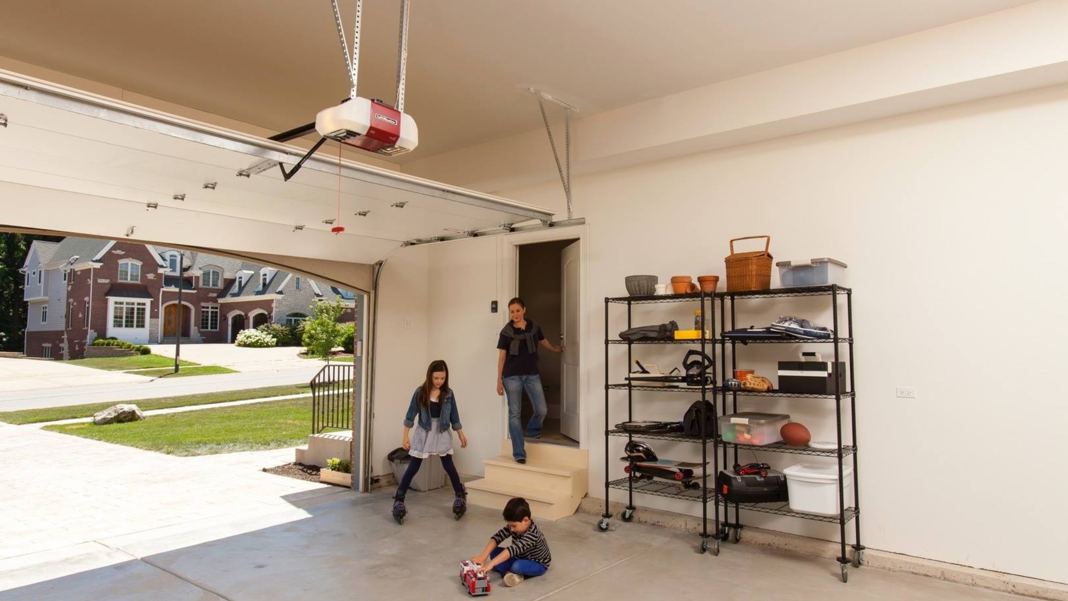 A mother and her two children having a fun time inside the garage with their door opened