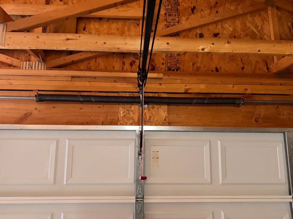Interior view of a garage door with a torsion spring system.