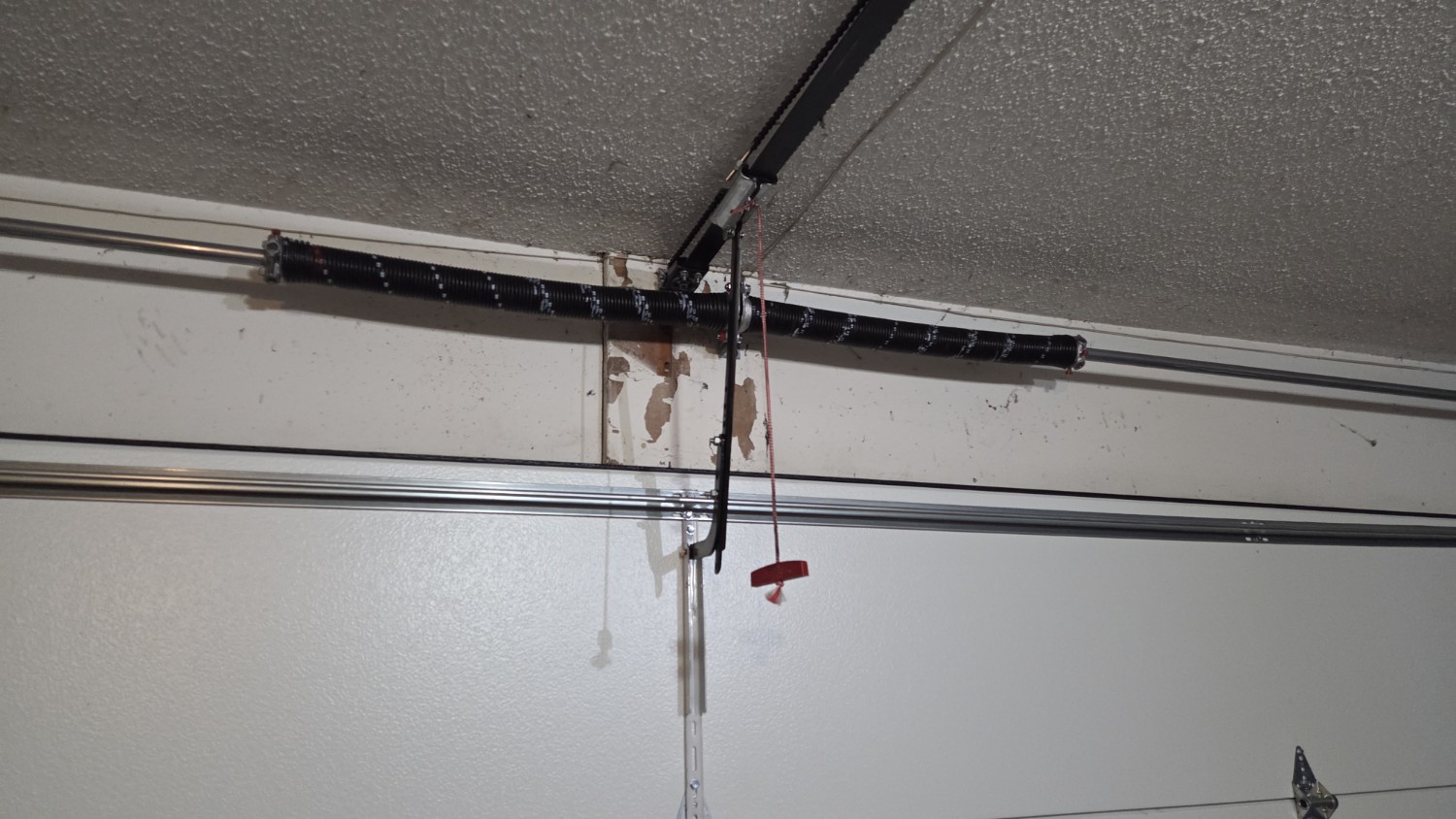 Garage door torsion spring system installed on a residential garage door.