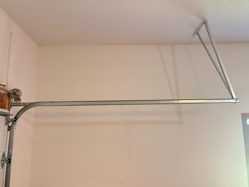Garage door roller repair showing the horizontal and curved track system installed