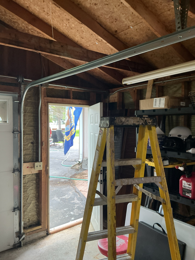 Garage door roller repair showing the overhead track and roller system