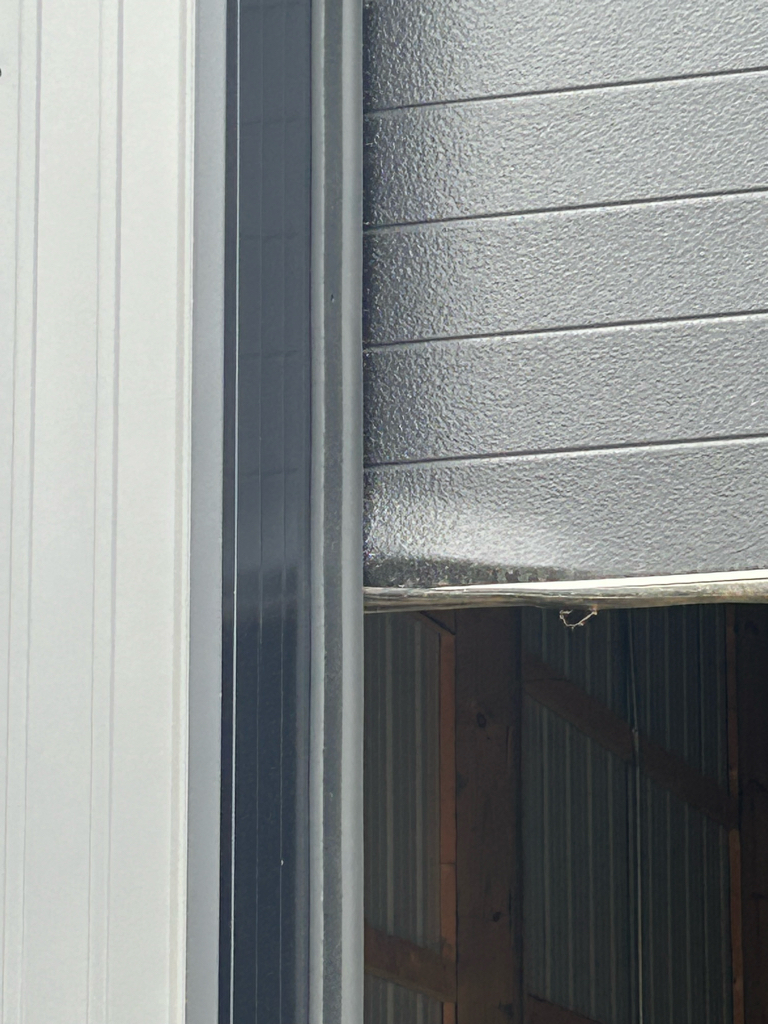 Commercial garage door repair showing overhead door hardware and springs