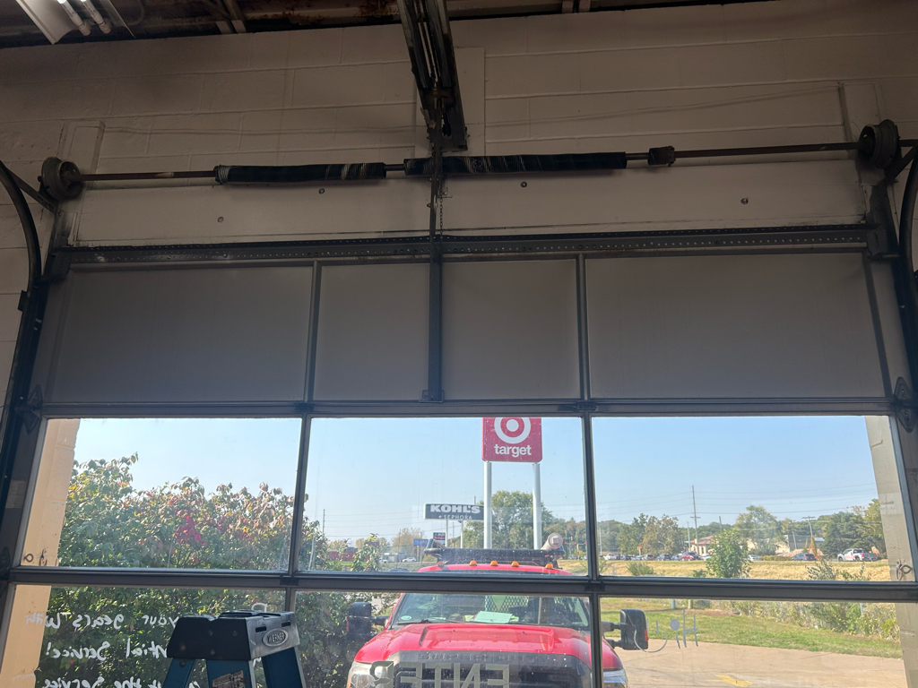 Commercial garage door repair for a sectional overhead door