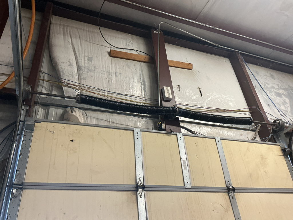 Commercial garage door repair service for an overhead sectional door 