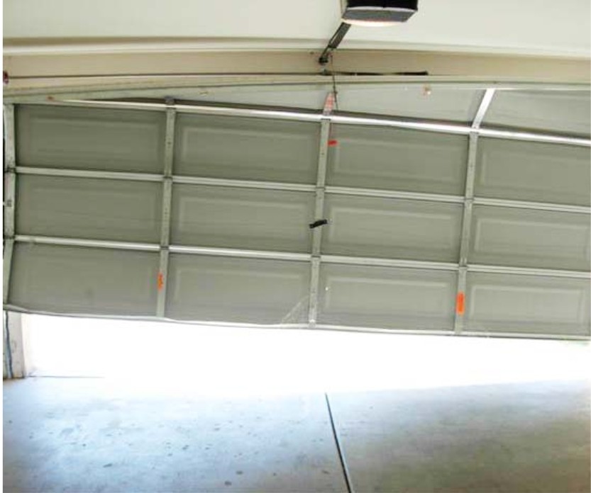Sectional garage door needing off-track repair and realignment