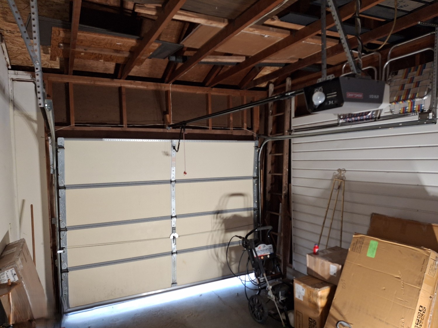 Stuck garage door requiring professional inspection and repair