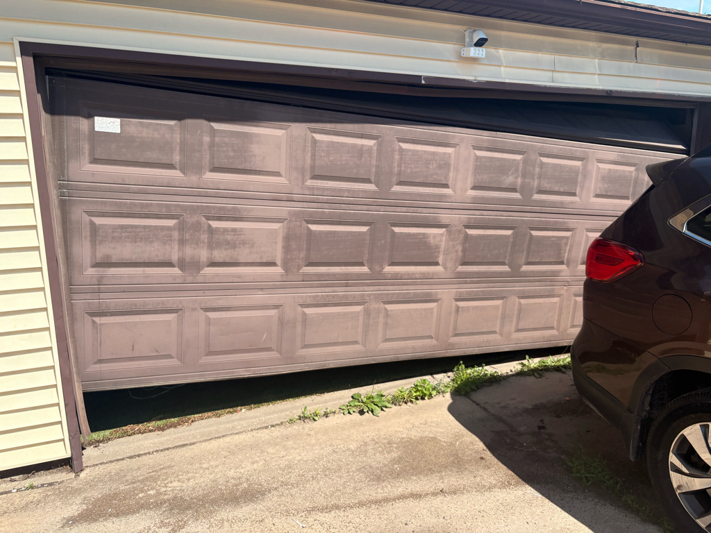 Garage door off-track repair for a misaligned sectional garage door