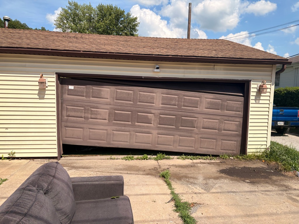 Garage door off-track repair for a misaligned sectional garage door